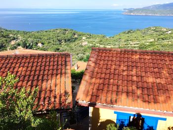 High angle view of townscape by sea against sky