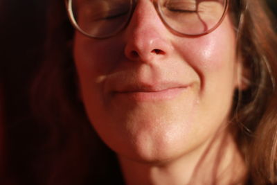 Close-up of a  woman facing the sun