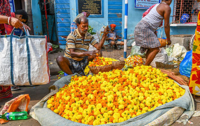 Woman for sale at market stall