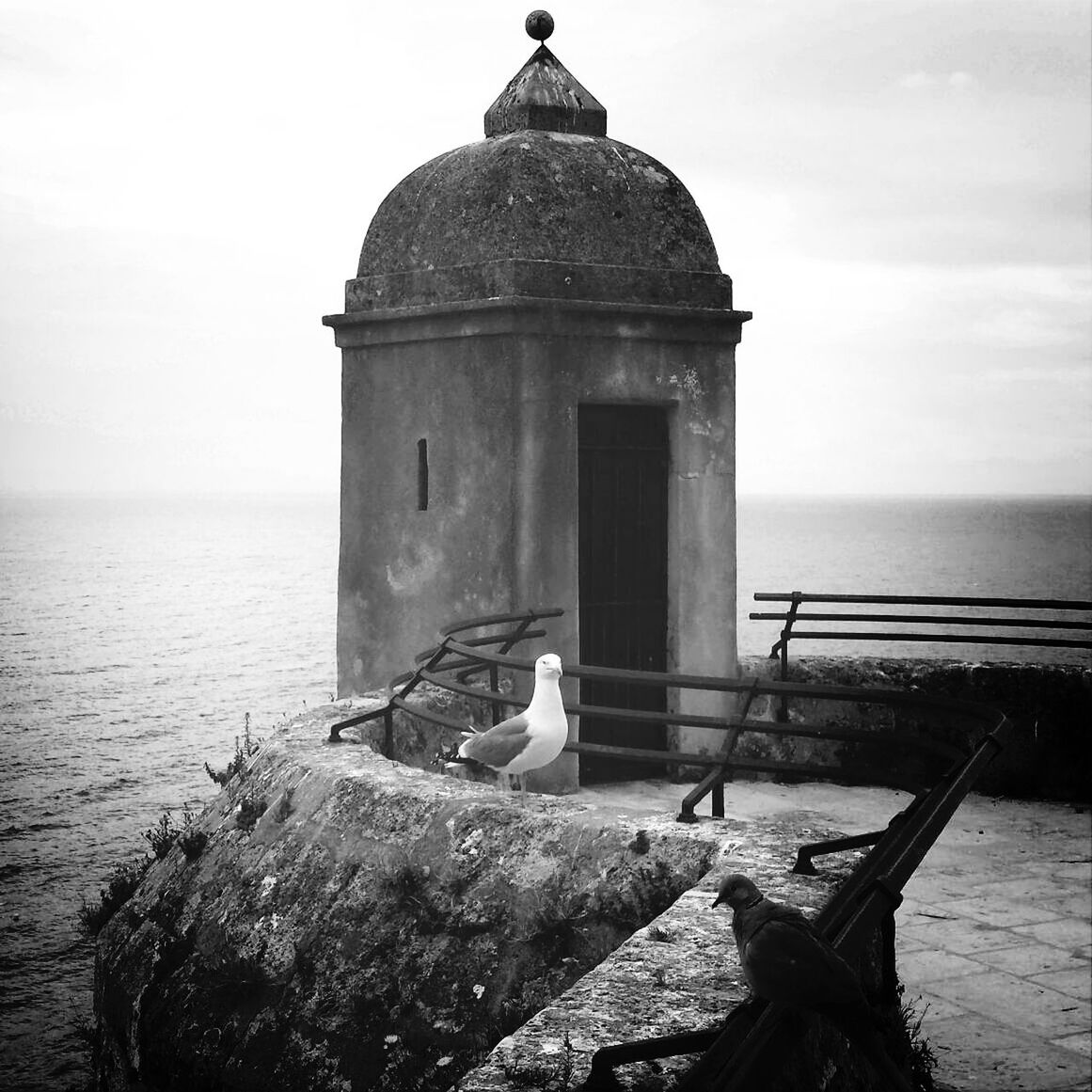 sea, water, horizon over water, sky, built structure, lighthouse, architecture, building exterior, old, tranquility, nautical vessel, nature, tranquil scene, abandoned, guidance, outdoors, day, pier, clear sky, boat