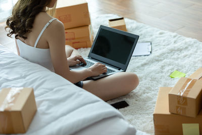 High angle view of woman using mobile phone at home