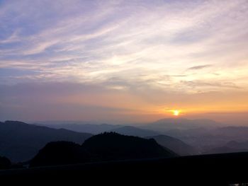 Scenic view of silhouette mountains against sky during sunset