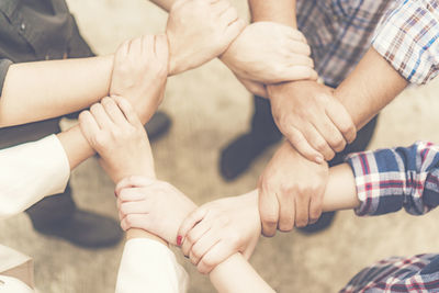 Cropped image of people forming hand chain