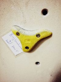 High angle view of yellow toy on wall