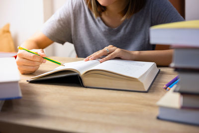 Midsection of woman reading book