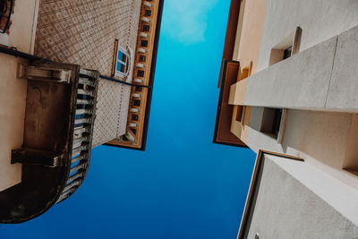 Low angle view of buildings against blue sky