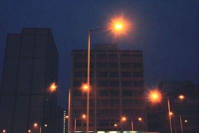 Low angle view of illuminated building against sky at night