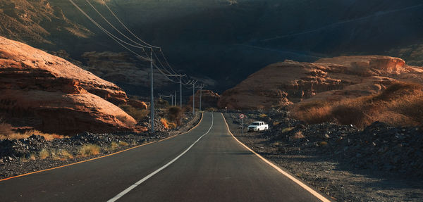 Empty road by mountain