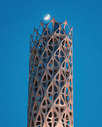 Low angle view of metallic structure against blue sky