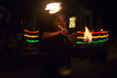 Man and fire burning at night