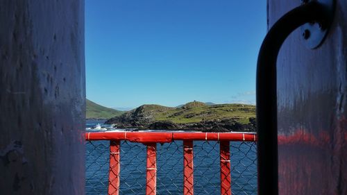 View of calm sea against clear blue sky