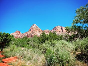 Scenic view of rocky mountains against clear blue sky