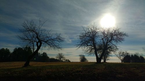 Scenic view of grassy field against cloudy sky