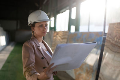 Young woman working at construction site