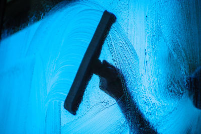 Close-up of person washing car