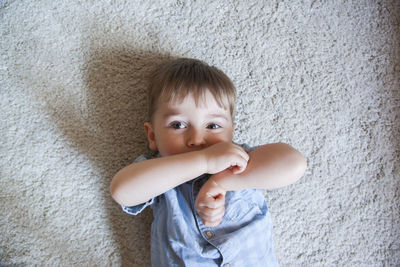 Portrait of cute boy against wall at home