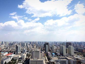 Skyscrapers against cloudy sky