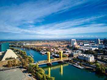 High angle view of river amidst buildings in city against sky