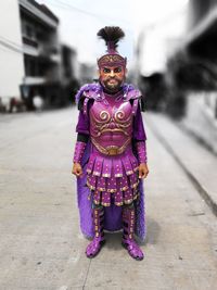 High angle portrait of man standing against purple wall