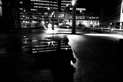 Illuminated city street and buildings at night