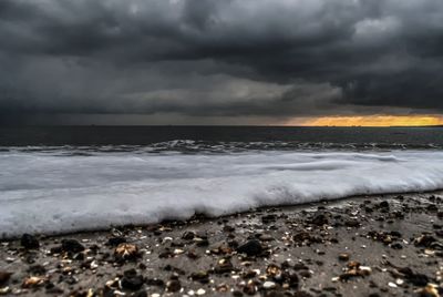 Scenic view of sea against dramatic sky