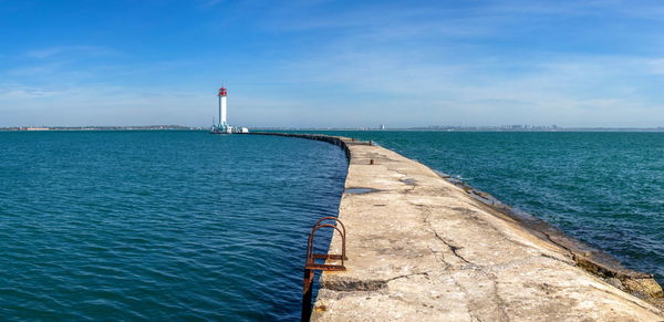 Lighthouse at the entrance to the harbor of odessa seaport, on a sunny summer day