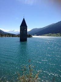 Tower reaching out from lake