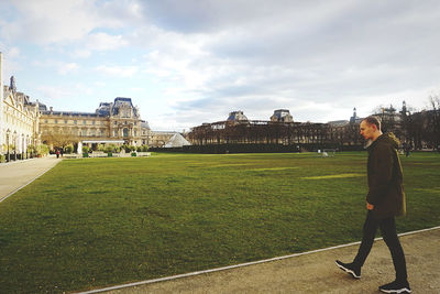 Side view of woman standing against sky