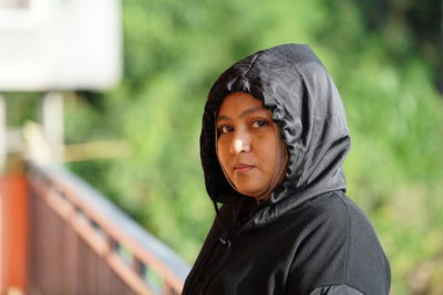 Portrait of young woman standing outdoors