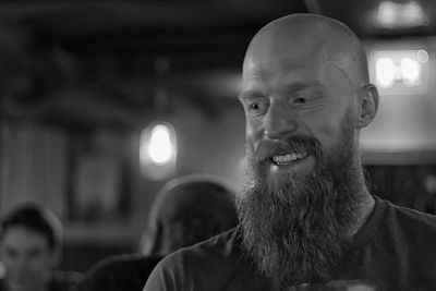 Happy bearded man at restaurant