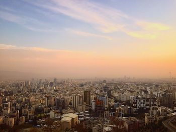 High angle view of illuminated buildings against sky during sunset