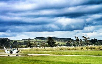 Scenic view of landscape against cloudy sky