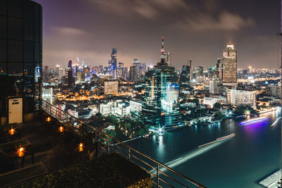 High angle view of illuminated buildings against sky at night