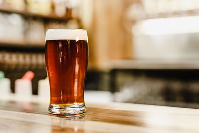 Close-up of beer glass on table