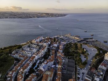 High angle view of buildings by sea against sky