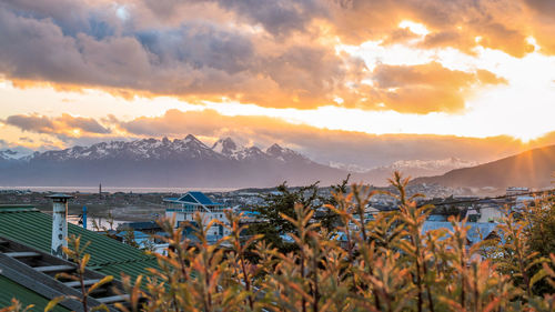 Scenic view of sea and mountains against sky during sunset