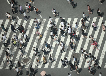 High angle view of people walking on road in city