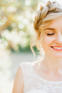 Close-up of smiling bride outdoors