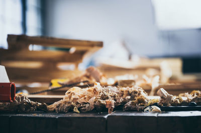 Close-up of shavings on table