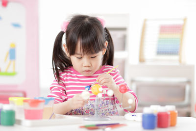 Young girl making craft for homeschooling