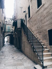 Walkway amidst buildings in city