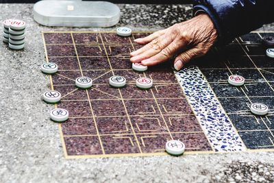 Cropped hand of man playing board game
