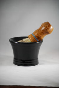Close-up of drink on table against white background