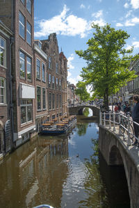 Canal amidst buildings against sky