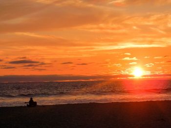 Scenic view of sea against orange sky