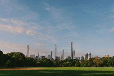 Scenic view of trees and buildings against sky