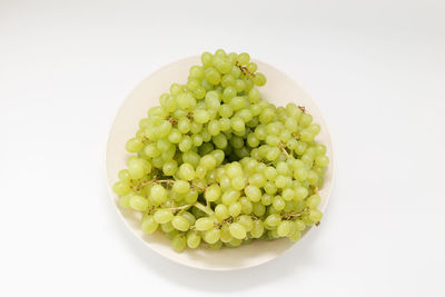 Directly above shot of fruits in bowl against white background