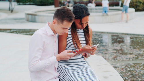 Side view of woman using mobile phone