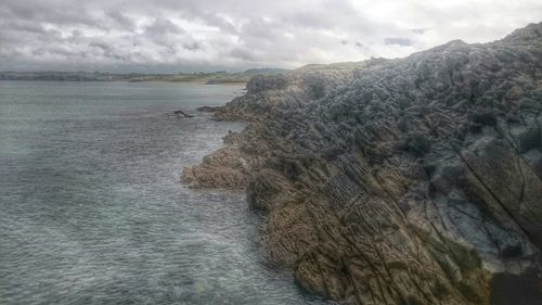 Scenic view of sea against cloudy sky