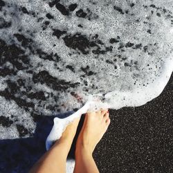 Low section of woman on sand